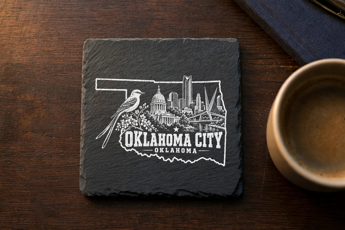 Square slate coaster featuring a white engraved Oklahoma City skyline and state map outline.
