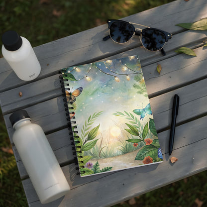 Notebook with watercolor butterflies and fairy lights design on a wooden table.