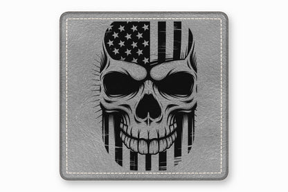 A square grey leather patch features a black and white graphic of a skull overlaid with an American flag.