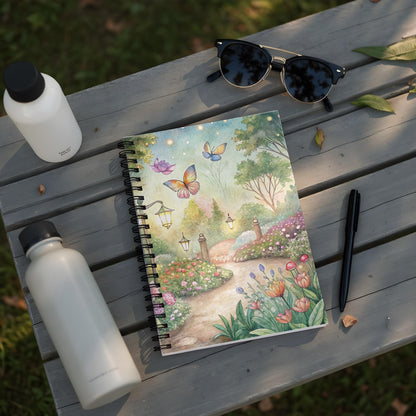 Spiral-bound notebook with a watercolor garden scene featuring butterflies and flowers.