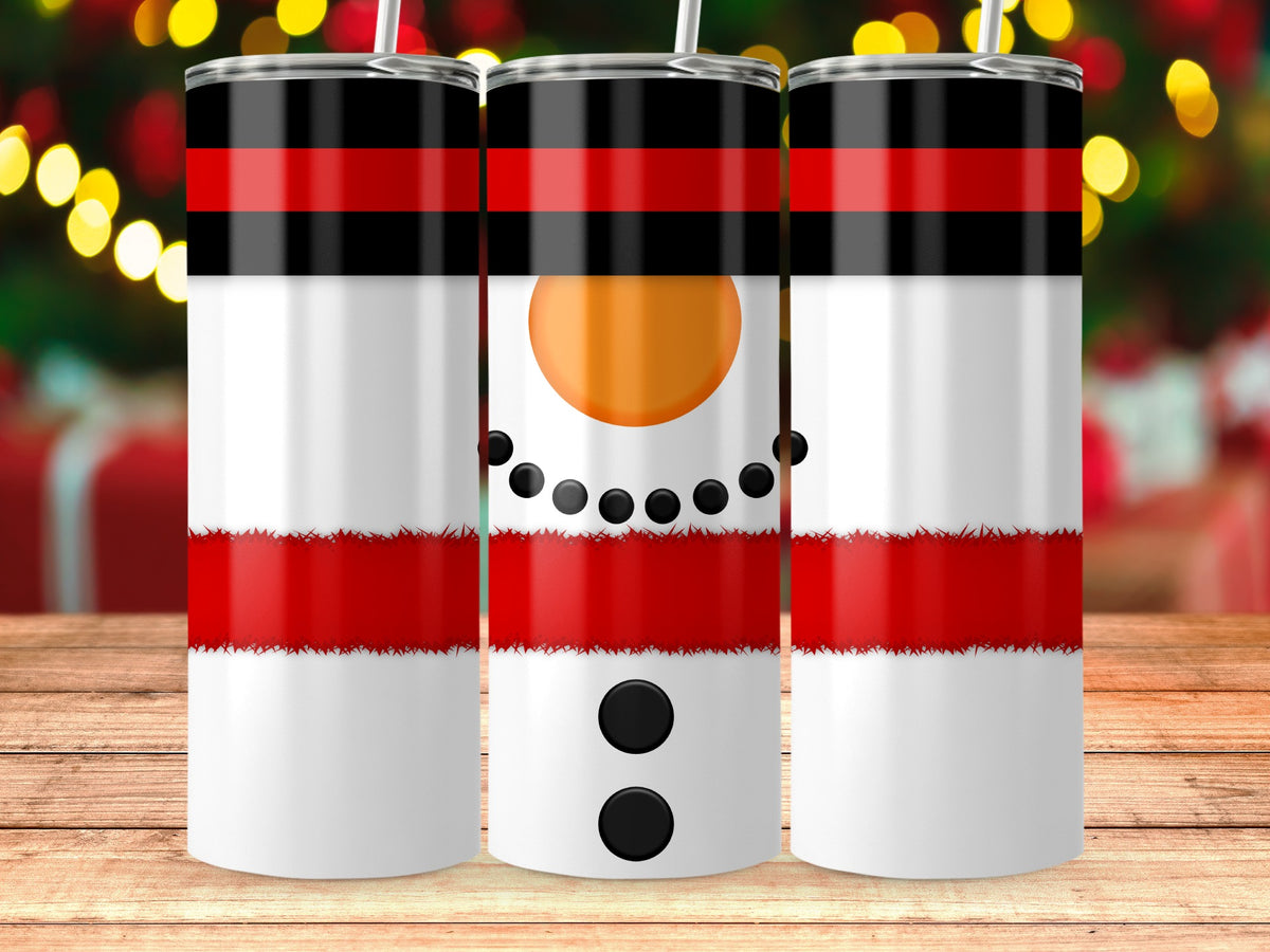 Three white tumblers with black and red snowman designs on a wooden table.