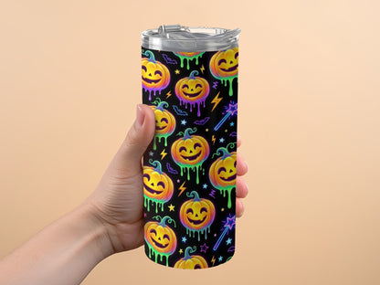Tumbler with repeating pattern of smiling pumpkins, bats, stars, and magic wands.