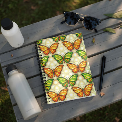Notebook with a colorful butterfly pattern on a wooden table with sunglasses.