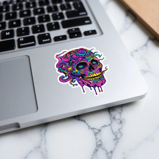 Dripping skull sticker with psychedelic swirling colors on a laptop.