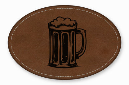 An oval brown leather patch features a black etched design of a frothy beer mug.