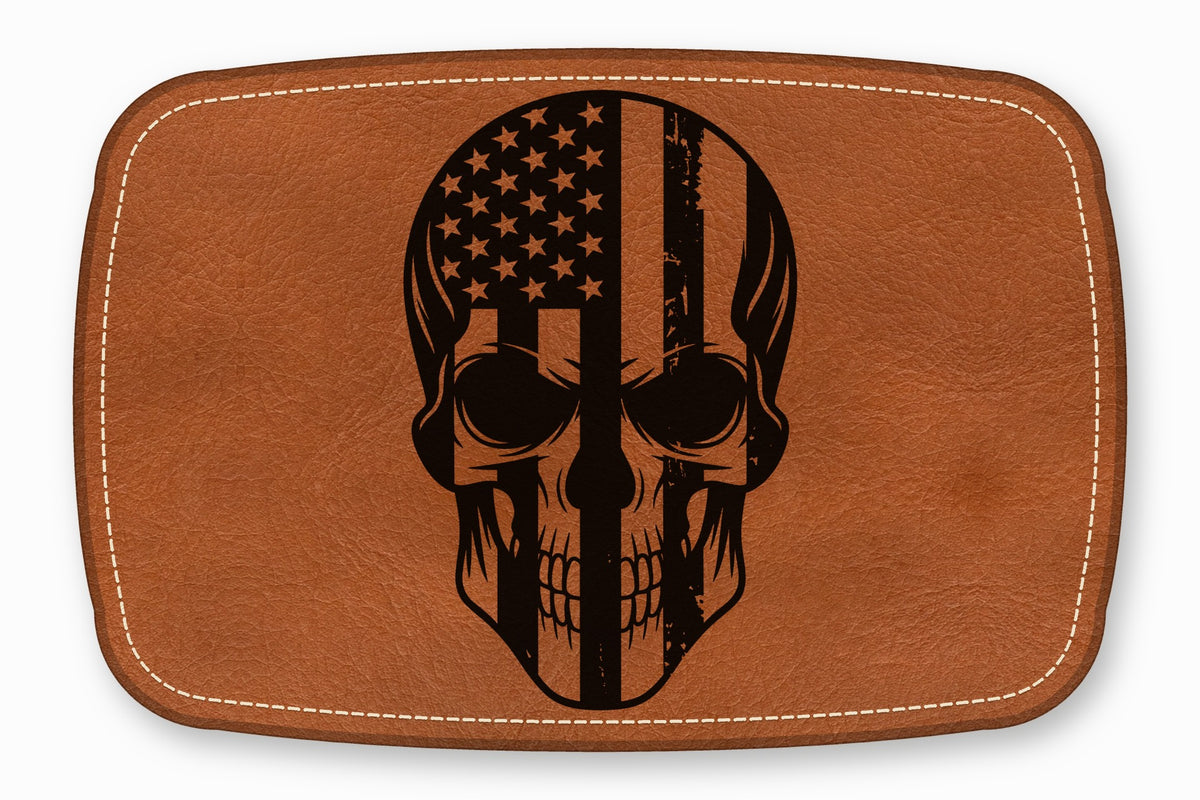 Brown leather patch with rounded corners, white border stitching, and a black skull and American flag graphic.