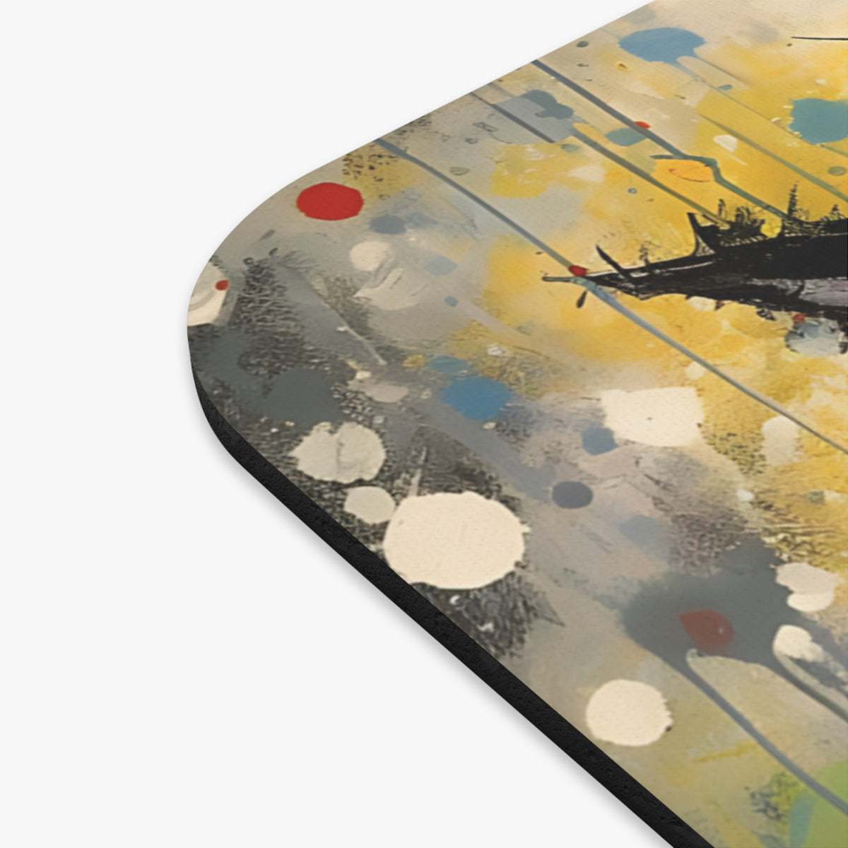 Close-up of a rectangular mousepad featuring an abstract painting with splatters of yellow, black, and blue paint.