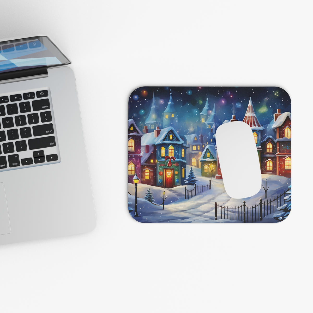 Mousepad with a snowy village scene featuring cozy houses and festive lights.