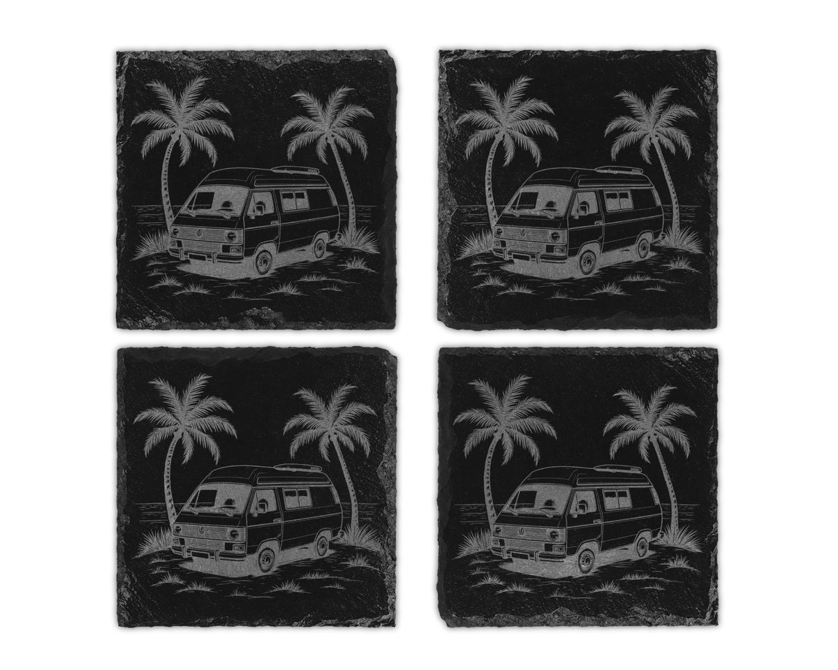 Four slate coasters etched with a vintage camper van and palm trees by the ocean.