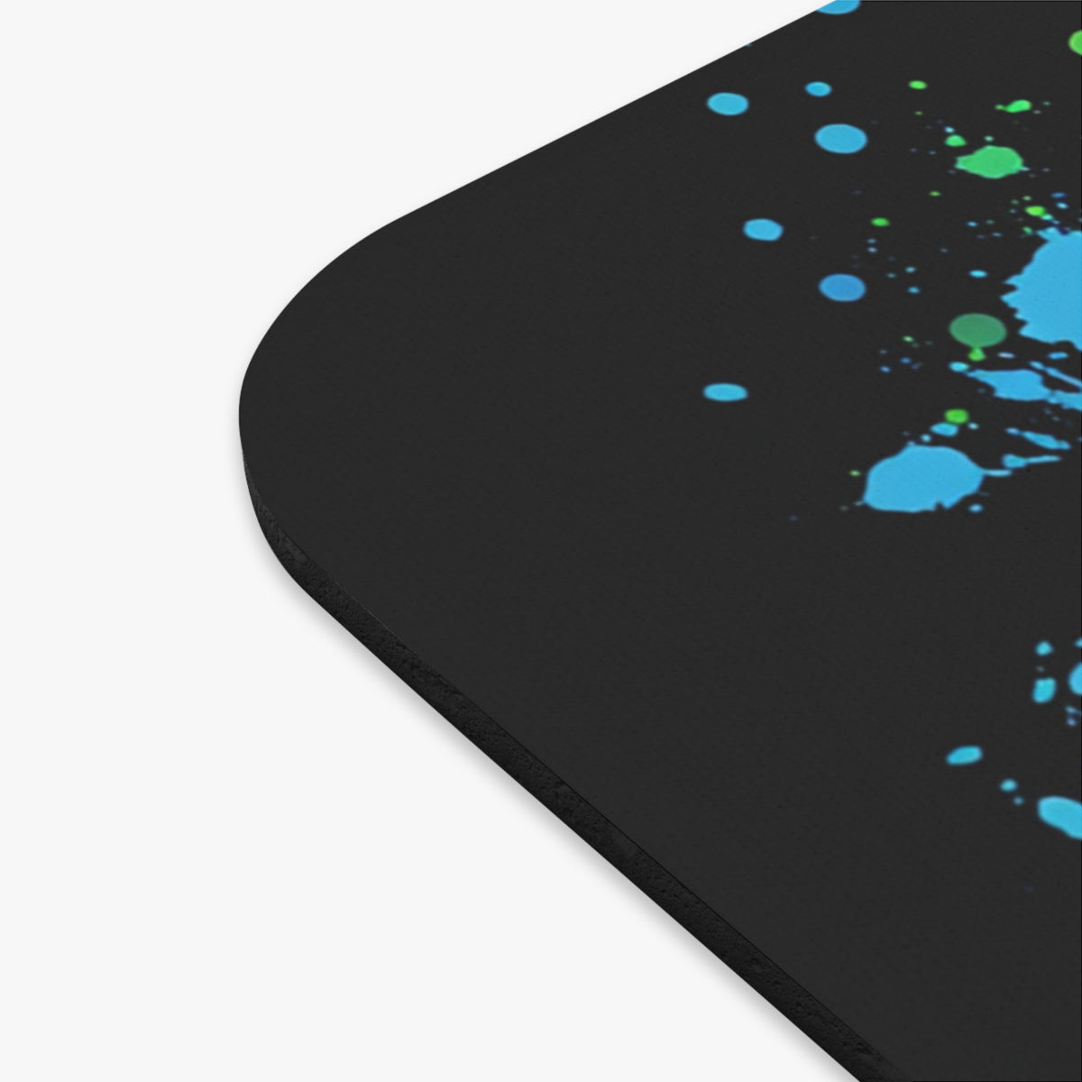 Black mousepad with blue and green ink splatter pattern.