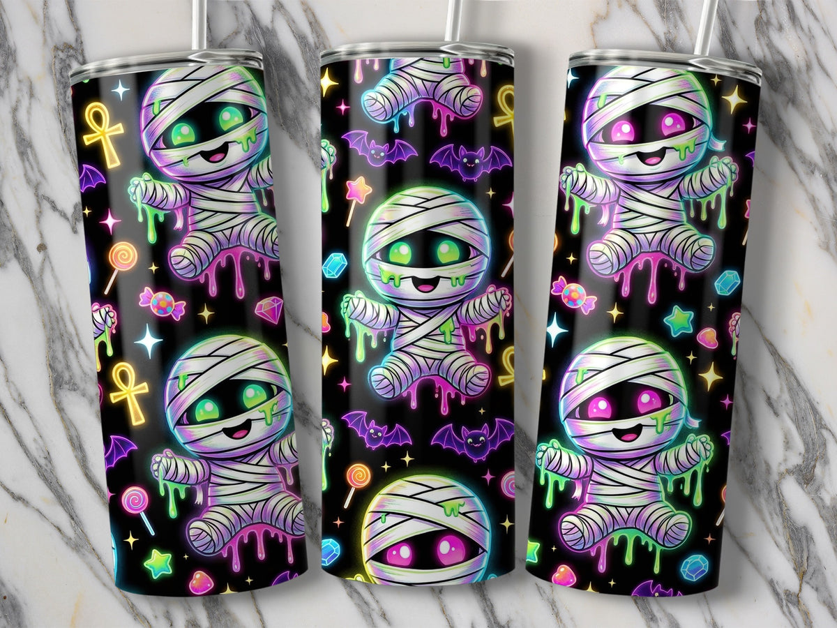Three tumblers with a black background and colorful mummy, candy, and bat designs.