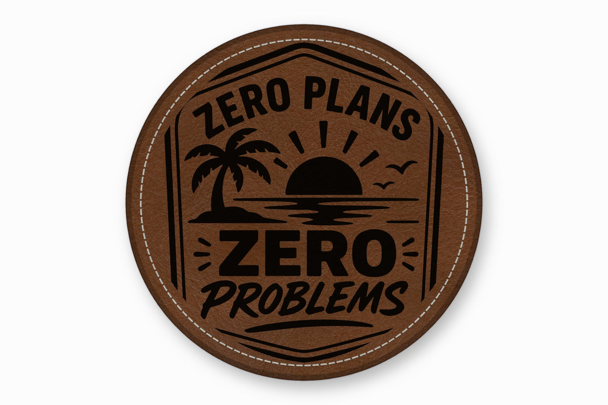A round brown leather patch features a black tropical sunset graphic and the text Zero Plans Zero Problems.