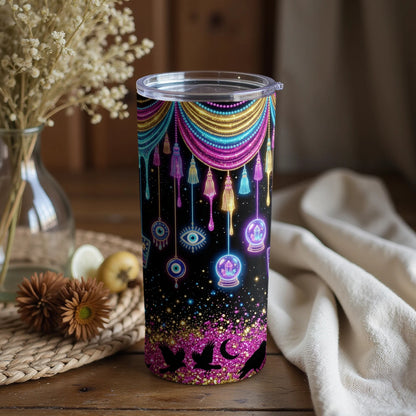 Black tumbler with mystical art featuring dripping beads, tassels, eyes, crystals, and birds.