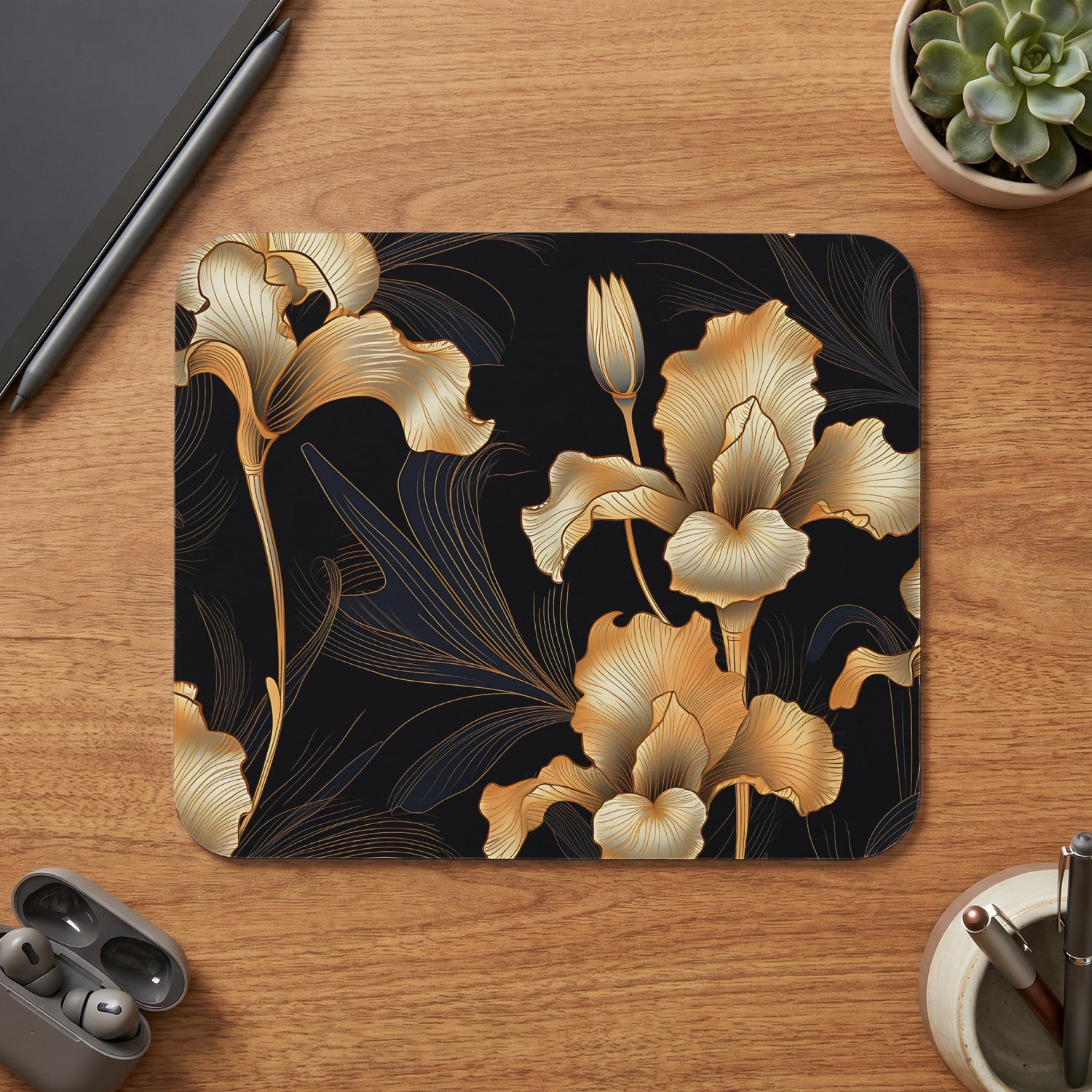 Mousepad with a gold iris floral pattern on a black background.