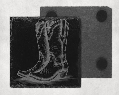 Black slate coaster with engraved cowboy boot design and felt backing.
