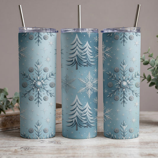 Three blue tumblers with snow and Christmas tree patterns, each with a silver straw.