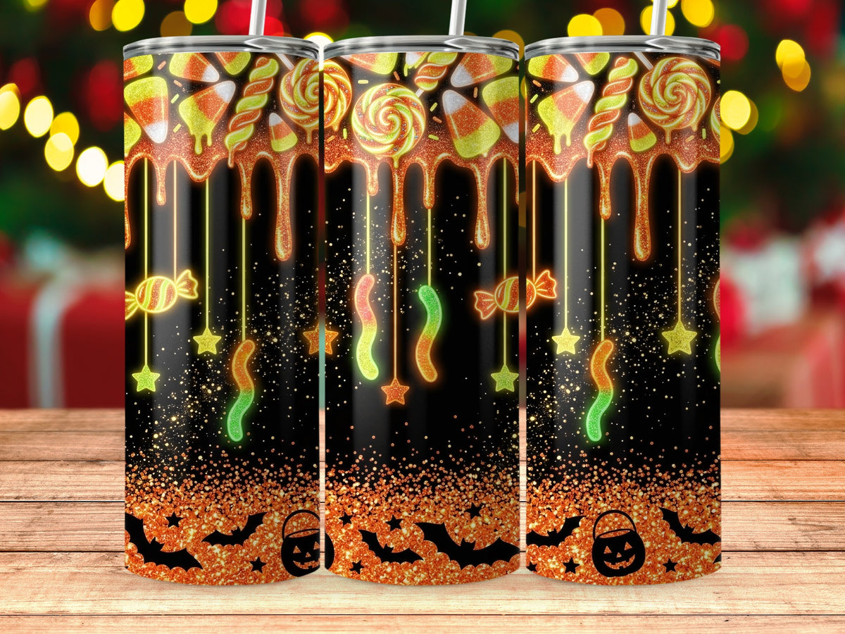 Halloween tumblers with candy corn, lollipops, gummy worms, bats, and pumpkins.