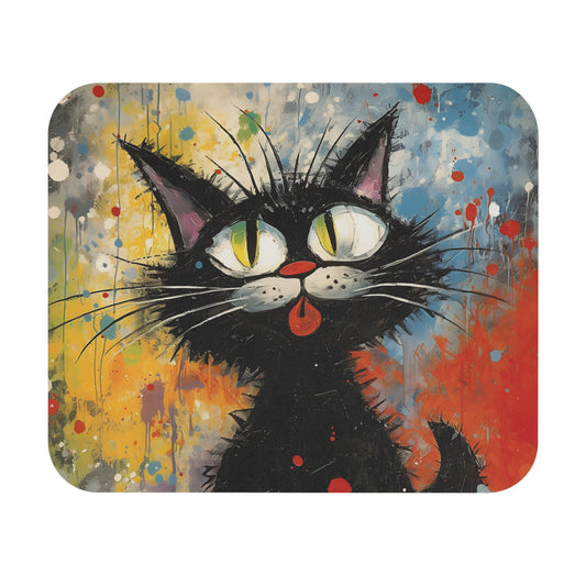Rectangular mousepad featuring an expressive cartoon black cat with large yellow-green eyes and a red tongue sticking out, set against a colorful, paint-splattered abstract background.