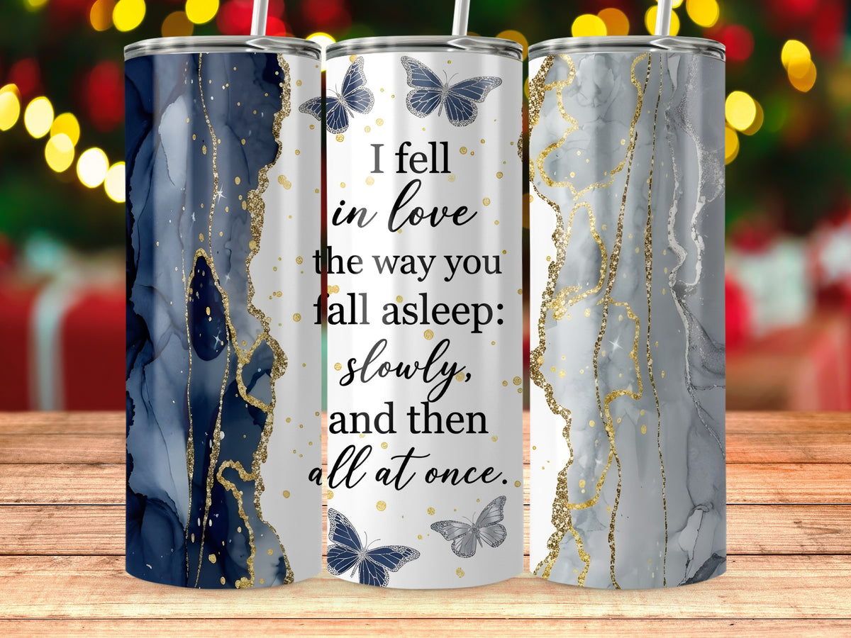 Tumbler with marble design, gold accents, butterflies, and quote: "I fell in love the way you fall asleep: slowly, and then all at once."