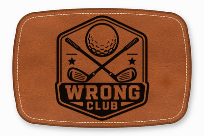 Brown leather patch with rounded corners featuring a black golf emblem and the text WRONG CLUB.