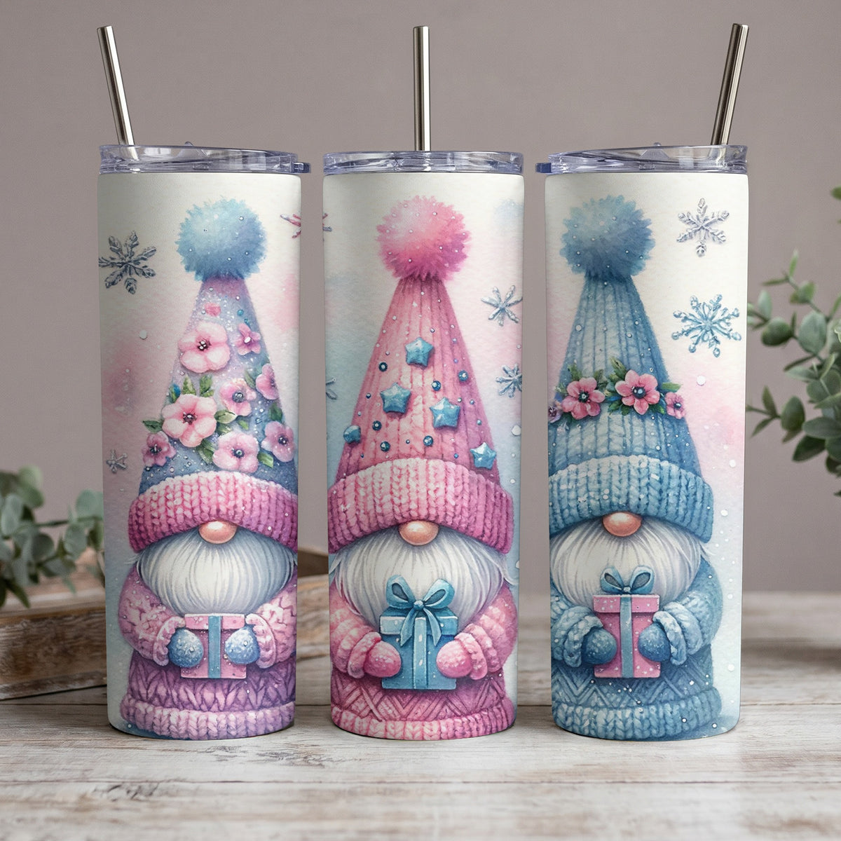 Three watercolor gnomes with colorful hats and gifts, surrounded by snowflakes.
