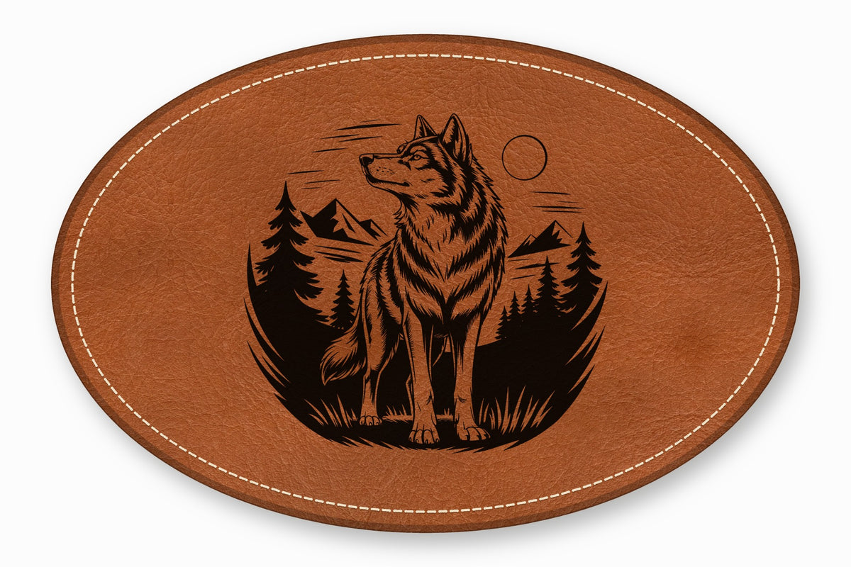 An oval brown leather patch with white stitching featuring an engraved design of a wolf standing in a forest.