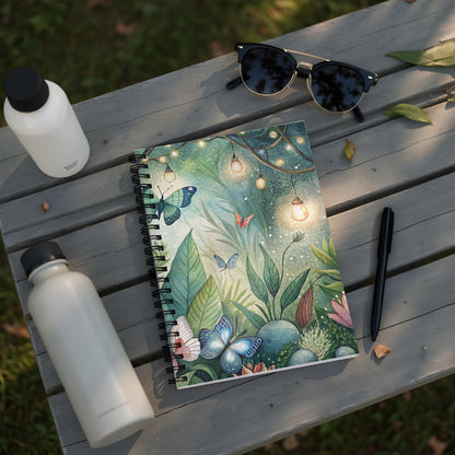 Spiral notebook with watercolor butterfly and light string illustration on cover.