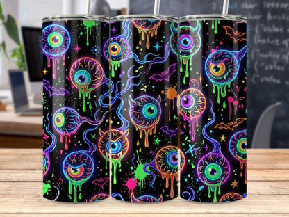 Tumbler with dripping neon eyeballs, bats, and stars on a black background.