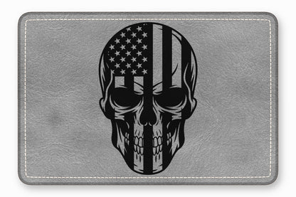 Gray leather rectangular patch with white stitched border and a black skull and American flag graphic.