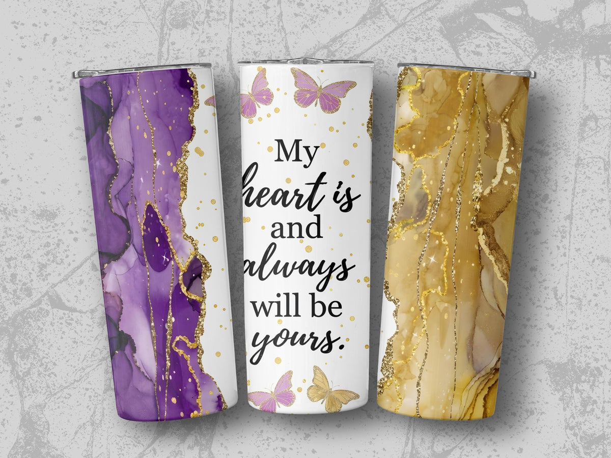 Three tumblers with abstract purple, gold, and marble designs and butterflies.