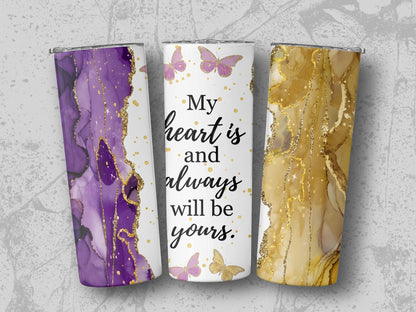Three tumblers with abstract purple, gold, and marble designs and butterflies.