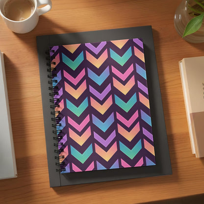 Spiral notebook with purple background and colorful chevron pattern.