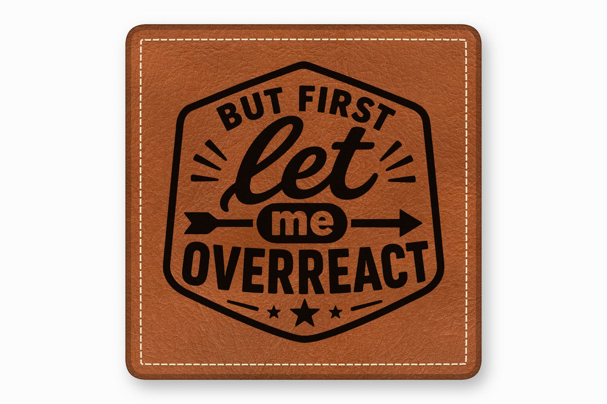 Brown square leather patch with white stitched borders and black text reading But First let me OVERREACT.
