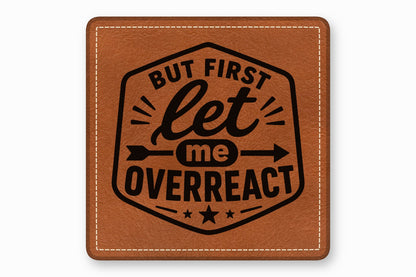 Brown square leather patch with white stitched borders and black text reading But First let me OVERREACT.