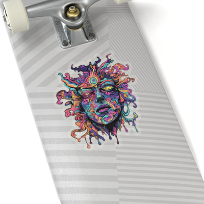 Vibrant, abstract face sticker on a grey striped skateboard deck.