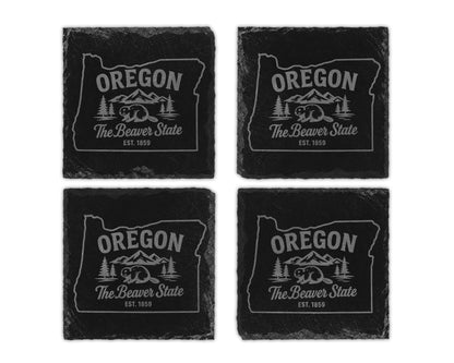 Four slate coasters featuring the Oregon state outline with beaver and mountains design.