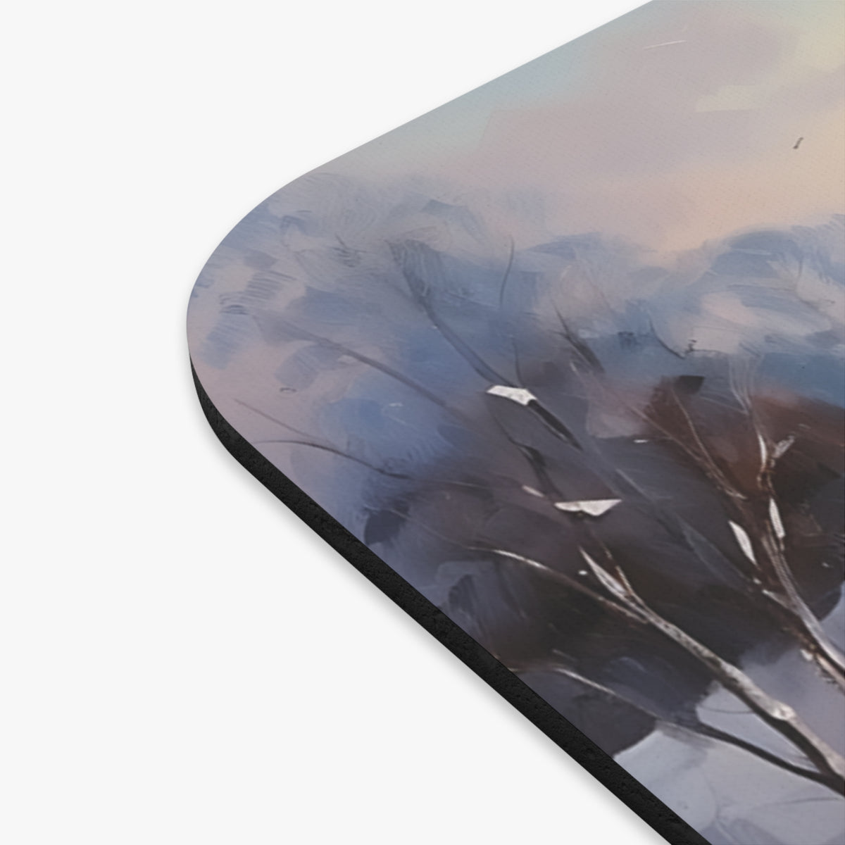 Abstract painting of bare branches against a moody sky on a mousepad.