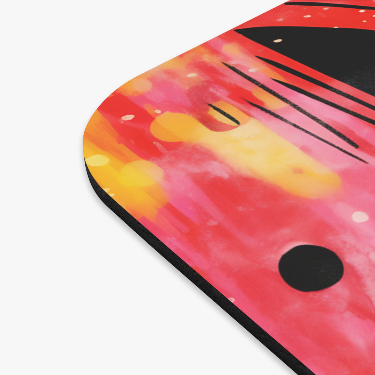 Close-up of a mousepad with an abstract watercolor design in red, orange, and black.