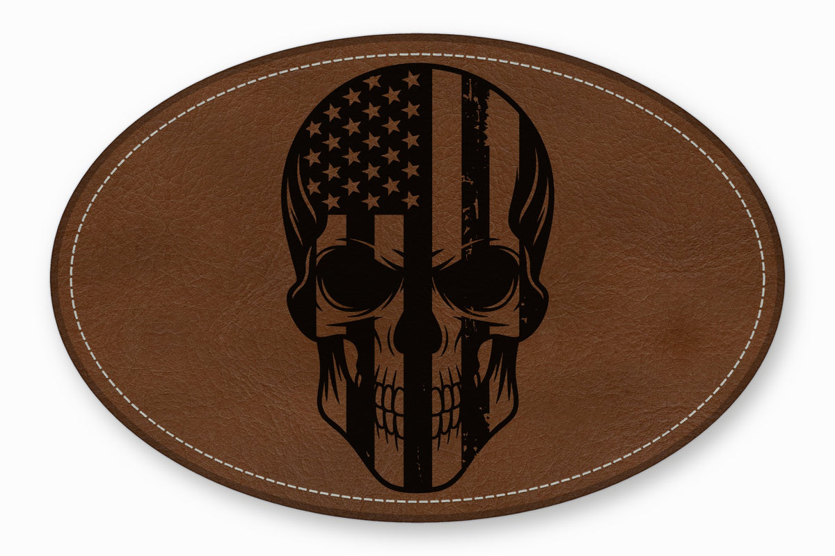 Oval brown leather patch with white stitched border featuring a black skull graphic overlaid with the American flag.
