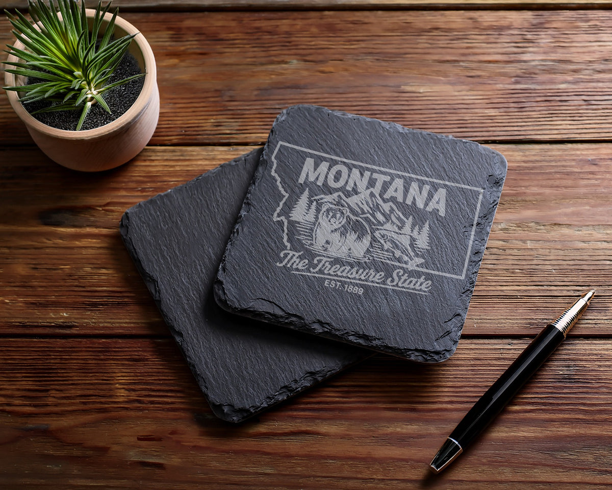Montana slate coasters with bear, fish, and mountains etched design.