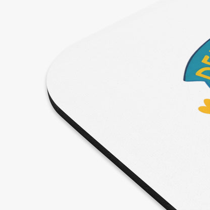 White mousepad with black border and cartoon rocket graphic.