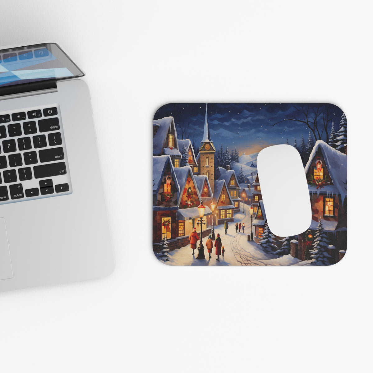 Mousepad features a snowy village scene with illuminated houses and people at dusk.