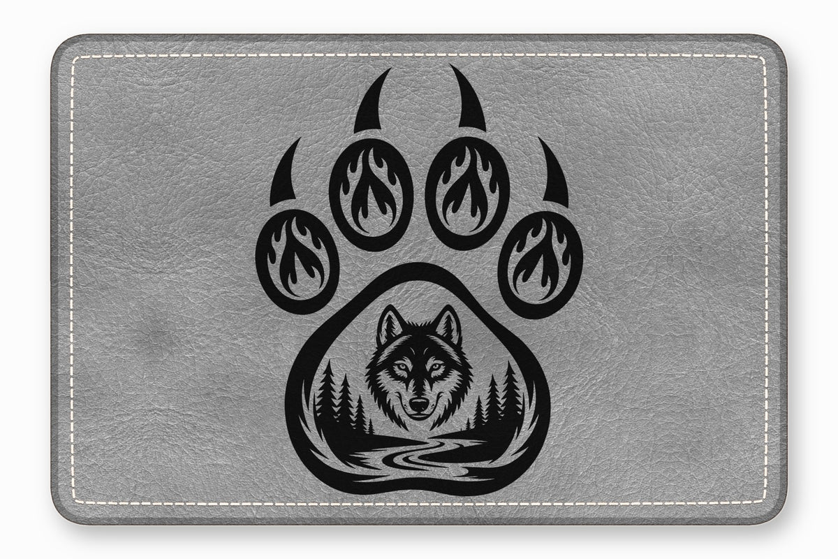 Grey leather patch with white stitched border featuring a black bear paw and wolf graphic.