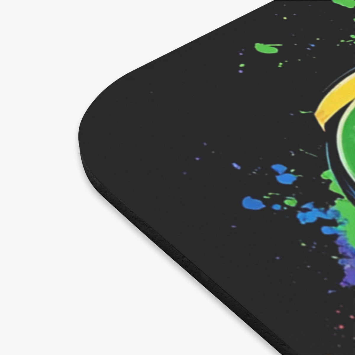 Black mousepad with colorful paint splatters and a partial yellow and green circular design.
