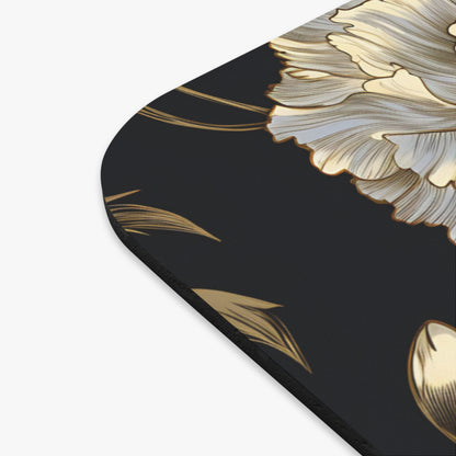 Close-up of a dark mousepad with a large, light gold floral design.