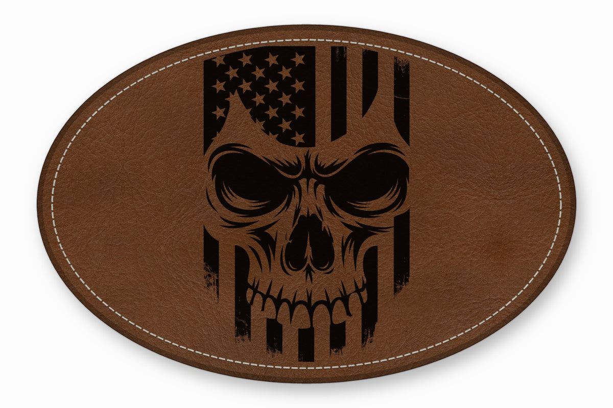 An oval brown leather patch with white stitched edges features a black distressed skull and American flag graphic.