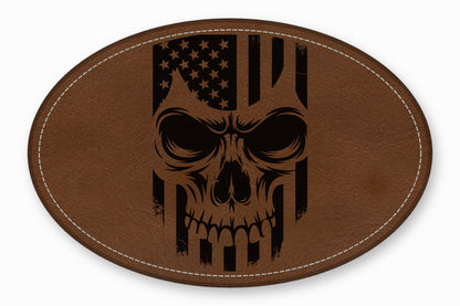 An oval brown leather patch with white stitched edges features a black distressed skull and American flag graphic.