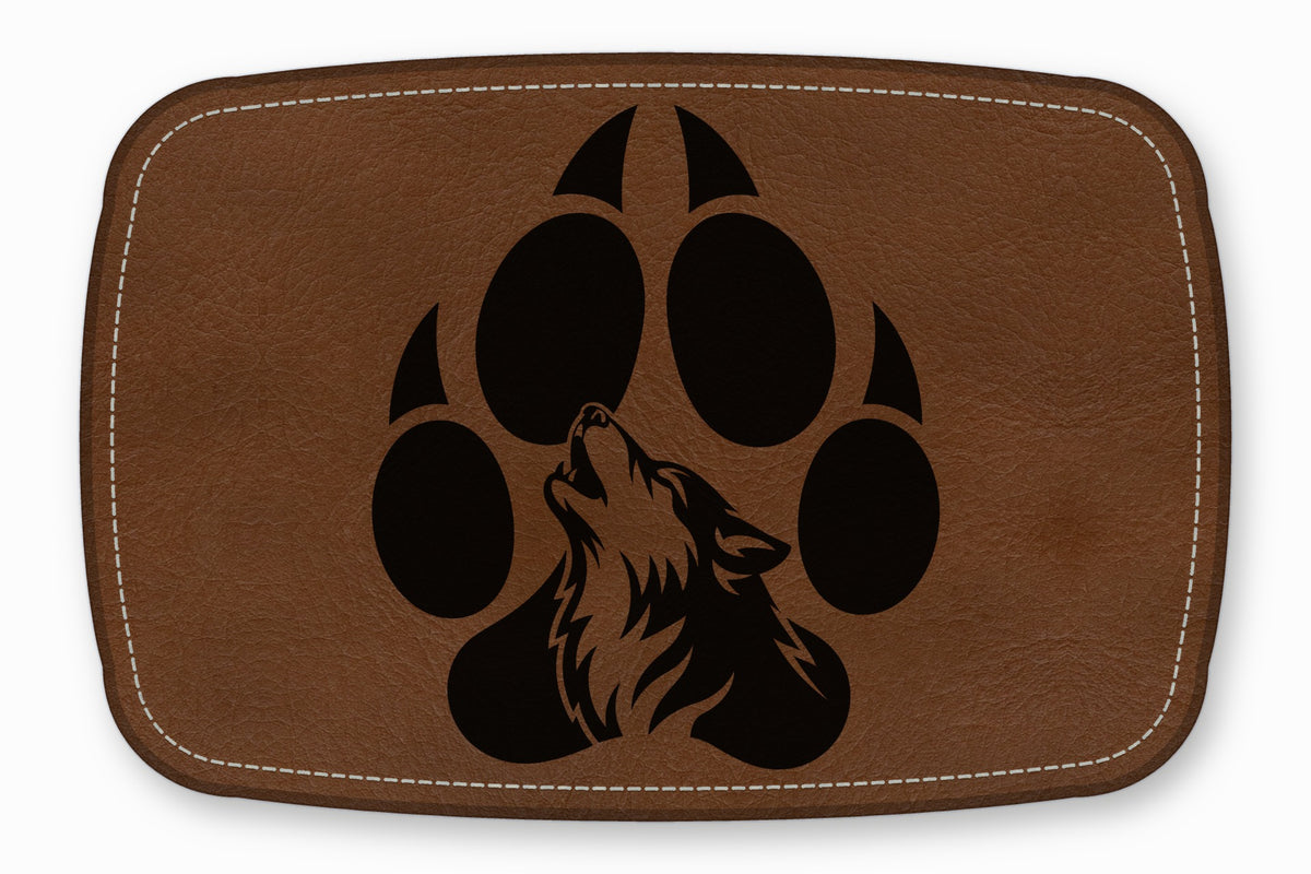 Brown leather patch with white stitched border, featuring a black silhouette of a howling wolf inside a paw print.