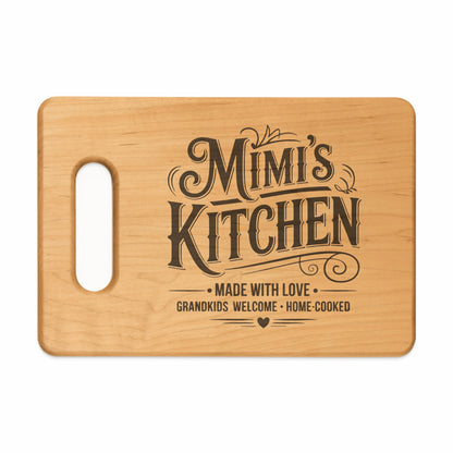 Wooden cutting board with "Mimi's Kitchen," "Made with Love," and "Grandkids Welcome Home-Cooked" etched on it.