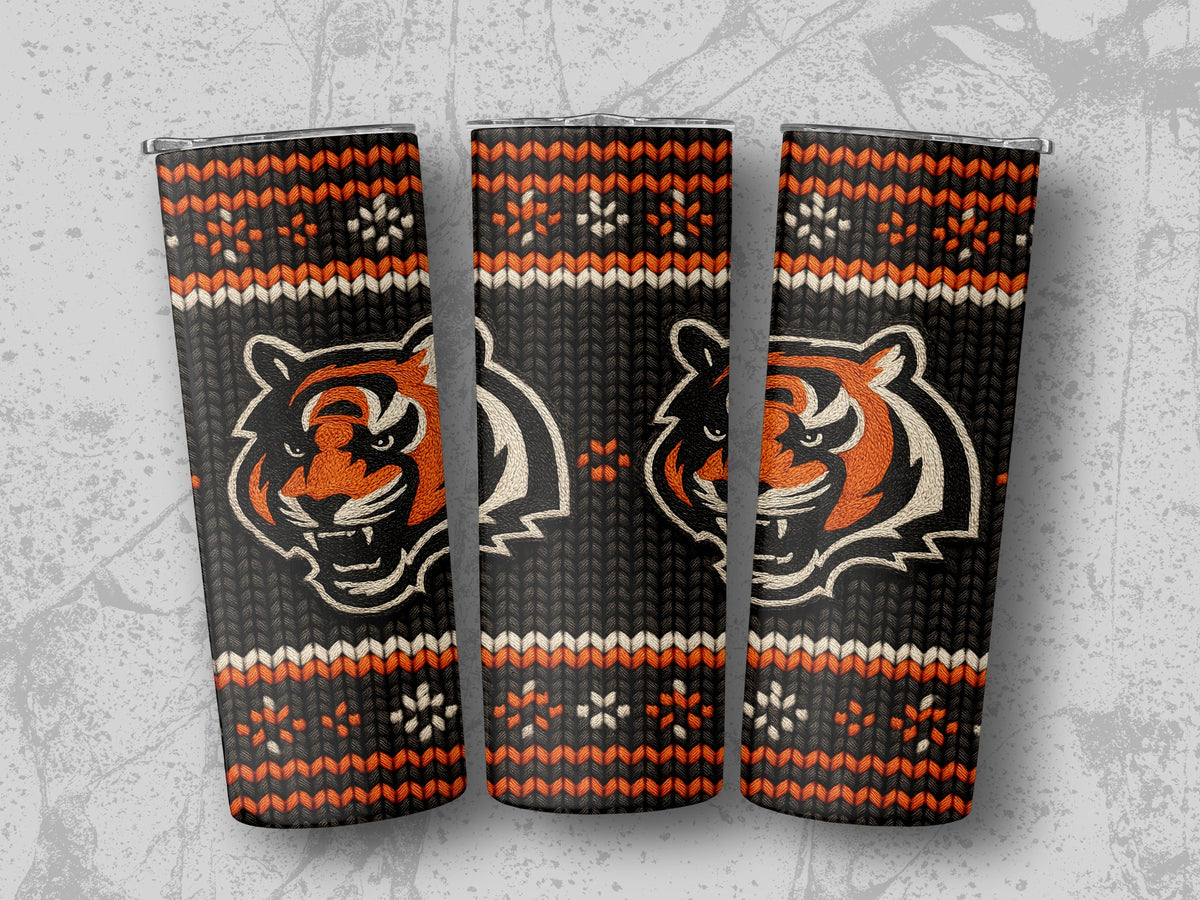 Three tumblers featuring a black knit pattern with orange and white tiger faces and snowflake designs.